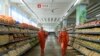 Employees spray disinfectant as part of preventative measures against the Covid-19 coronavirus at the Yokjon Department Store in Pyongyang on Oct. 20, 2021.