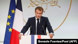 FILE - French president Emmanuel Macron delivers a speech during a ceremony in memory of the Harkis, Algerians who helped the French Army in the Algerian War of Independence, at the Elysee Palace in Paris, on Sept. 20, 2021. 