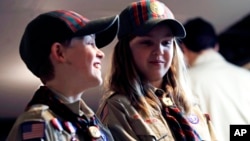 In a Thursday, March 1, 2018 photo, Ian Weir, left, smiles as he stands with his twin sister Tatum after a cub scout meeting in Madbury, N.H. (AP Photo/Charles Krupa)