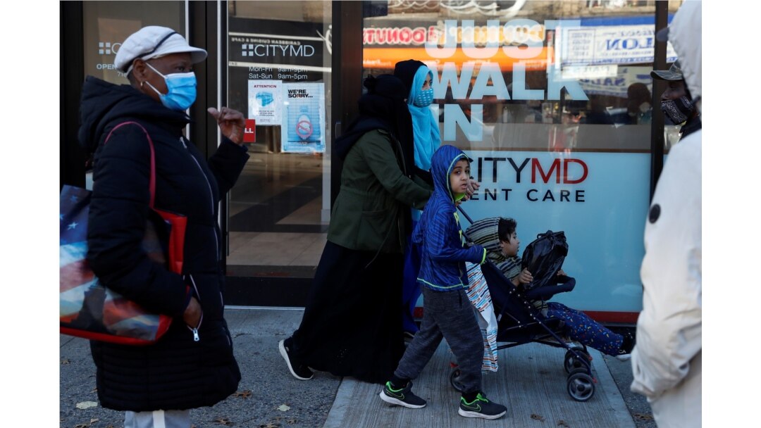 People wear protective face masks while waiting in line at a CityMD Urgent Care, as the global outbreak of the coronavirus disease (COVID-19) continues, in the Brooklyn borough of New York, U.S., November 16, 2020. REUTERS/Shannon Stapleton