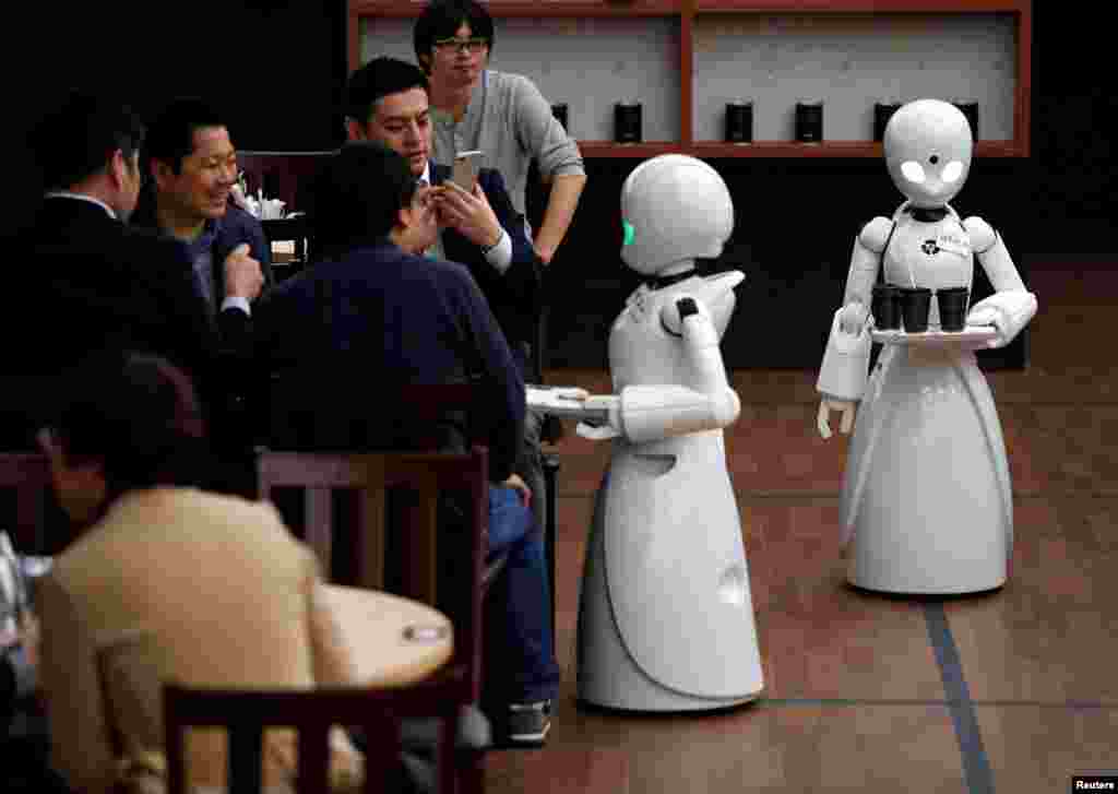 Remotely controlled robots OriHime-D, developed by Ory Lab Inc. to promote employment of disabled people, serve customers at a cafe in Tokyo, Japan.