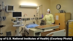 FILE - Workers must wear protective gear to care for patients with Ebola or other infectious diseases in the NIH Clinical Center's high containment unit. (Photo courtesy of the U.S. National Institutes of Health)