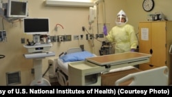 FILE - Workers must wear protective gear to care for patients with Ebola or other infectious disease in the NIH Clinical Center's high containment unit. (Photo courtesy of the U.S. National Institutes of Health)