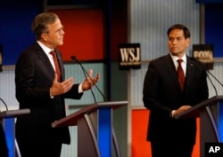 FILE - Jeb Bush, left, speaks as Marco Rubio listens during Republican presidential debate at Milwaukee Theatre, Tuesday, Nov. 10, 2015, in Milwaukee.