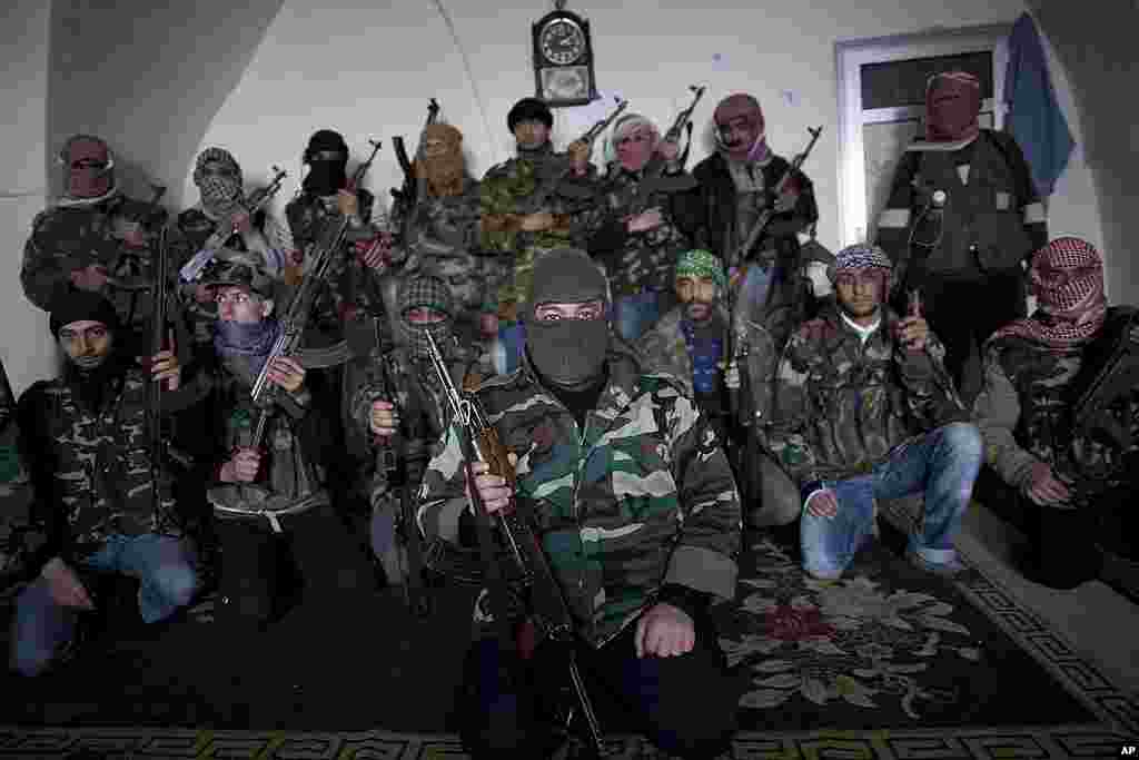 Free Syrian Army fighters pose for a portrait at their headquarters in Idlib. (AP)