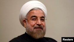 Iran's President Hassan Rouhani listens during a meeting with U.N. Secretary-General Ban Ki-moon on the sidelines of the U.N. General Assembly in New York, Sept. 23, 2014.