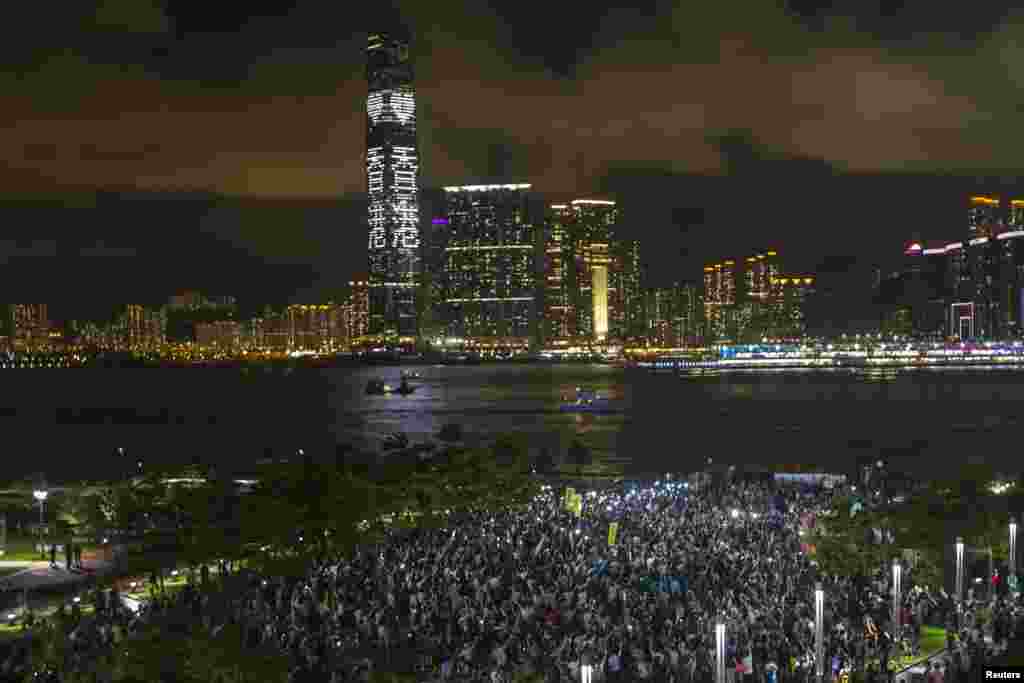 Pro-democracy protesters hold up their mobile phones during a campaign to kick off the Occupy Central civil disobedience event in Hong Kong, Aug. 31, 2014.