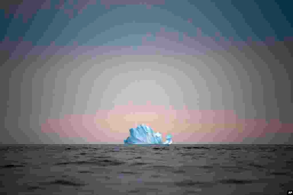 A large iceberg floats away near Kulusuk, Greenland, on Aug. 15, 2019. (AP Photo/Felipe Dana)