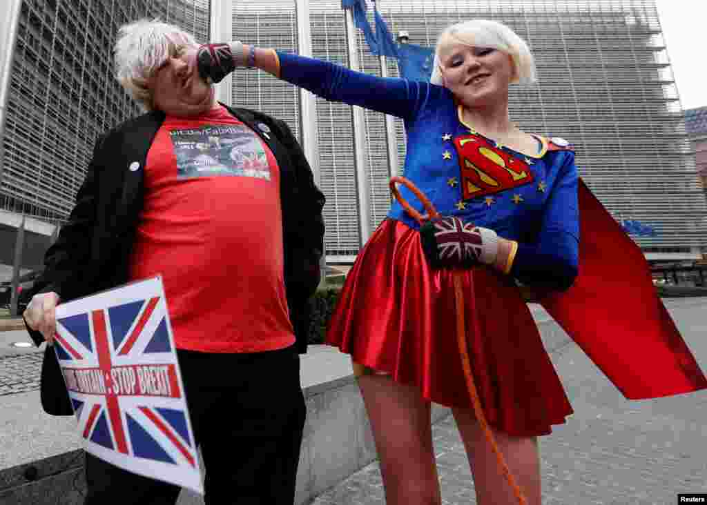Britain&#39;s anti-Brexit activist Madeleina Kay, who nicknamed herself as &quot;EU Supergirl,&quot; and fellow activist Drew Galdron, who is also an impersonator of British Foreign Secretary Secretary Boris Johnson, perform outside the European Commission headquarters in Brussels, Belgium.
