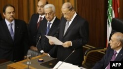 Newly elected Lebanese President Michel Aoun (C) gives a speech next to the Parliament Speaker Nabih Berri (R) as he takes an oath after he was elected at the Lebanese parliament in downtown Beirut, Oct. 31, 2016.