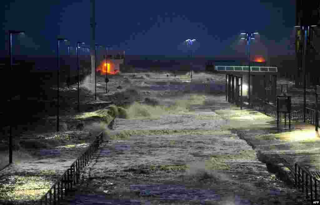 Waves lash the ferry pier on the North Sea coast in Dagebuell, Germany, as storm front Xaver hits the country.