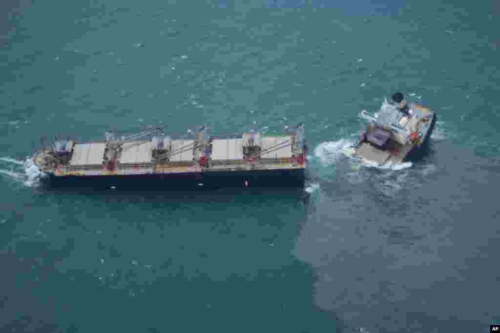 This photo provided by the Japan Coast Guard shows a vessel that has broken apart and leaked oil off Hachinohe, northeastern Japan. The Panamanian-registered cargo ship, Crimson Polaris, ran aground and later broke in two parts and was spilling oil into the sea, Japanese Coast Guard said.