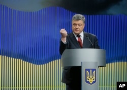 FILE - Ukrainian President Petro Poroshenko gestures while speaking during a news conference in Kyiv, Ukraine, Jan. 14, 2016.