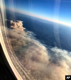 Smoke from wildfires burning in Northern California obscures the Sierra Nevada in this view from an airliner approaching Sacramento, Calif., Nov. 9, 2018.