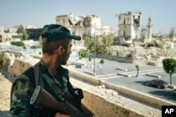 A Syrian soldier guards streets in Aleppo, Syria, Sept. 12, 2017.