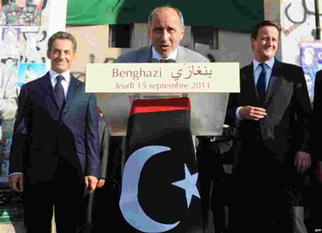 French President Nicholas Sarkozy, left, and British Prime Minister David Cameron, right, look on as Libya's NTC leader Mustafa Abdul-Jalil, center, delivers a speech during their visit to Benghazi, Libya, Thursday, Sept. 15, 2011. Cameron and Sarkozy gav
