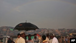 A rainbow forms in the horizon, as Rohingya refugees gather at Thangkhali refugee camp in Cox's Bazar, Bangladesh, Oct. 5, 2017. 