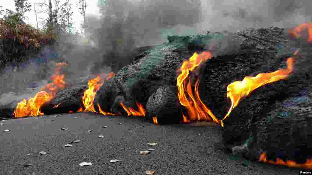 A lava flow is seen on a road in Pahoa, Hawaii, U.S.