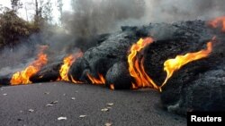 Lava is seen flowing down a road in Pahoa, Hawaii, May 18, 2018.