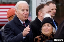 U.S. President Joe Biden gestures after delivering remarks on infrastructure construction projects from the NH 175 bridge across the Pemigewasset River in Woodstock, New Hampshire, November 16, 2021.