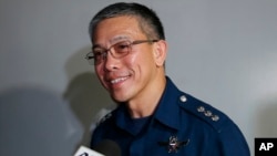 Col. Restituto Padilla, Spokesman of the Armed Forces of the Philippines, talks briefly to the media on the latest video of kidnapped Canadians, a Norwegian and a Filipino woman, as he arrives for a meeting with Foreign Affairs officials 2015 at suburban Pasay city south of Manila, Philippines, Nov. 4, 2015.