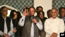 Former Prime Minister and leader of the Pakistan Muslim League-N party Nawaz Sharif, center, addresses his supporters at a party office in Lahore, May 11, 2013.