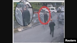 A still image taken from CCTV video and obtained by TRT World claims to show Saudi journalist Jamal Khashoggi, highlighted in a red circle by the source, as he stands with his fiancee Hatice Cengiz outside the Saudi Arabia's Consulate in Istanbul.