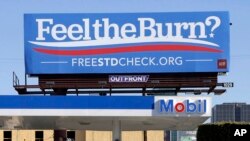 FILE - This April 1, 2016 file photos shows a billboard above a gas station that reads "Feel The Burn," a play on then-presidential candidate Bernie Sanders' campaign slogan, "Feel The Bern." It's actually promoting testing for sexually transmitted diseases.