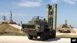 FILE - This photo made from the footage taken from the Russian Defense Ministry official web site on Nov. 27, 2015, shows Russian S-400 air defense missiles being deployed at the Hemeimeem air base in Syria.