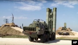 FILE - This photo made from footage taken from the Russian Defense Ministry official website on Nov. 27, 2015, shows Russian S-400 missiles being deployed at the Hemeimeem air base in Syria.