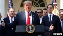 U.S. President Donald Trump acknowledges U.S. Trade Representative Robert Lighthizer and White House senior adviser Jared Kushner as he delivers remarks on the United States-Mexico-Canada Agreement (USMCA) during a news conference in the Rose Garden of th