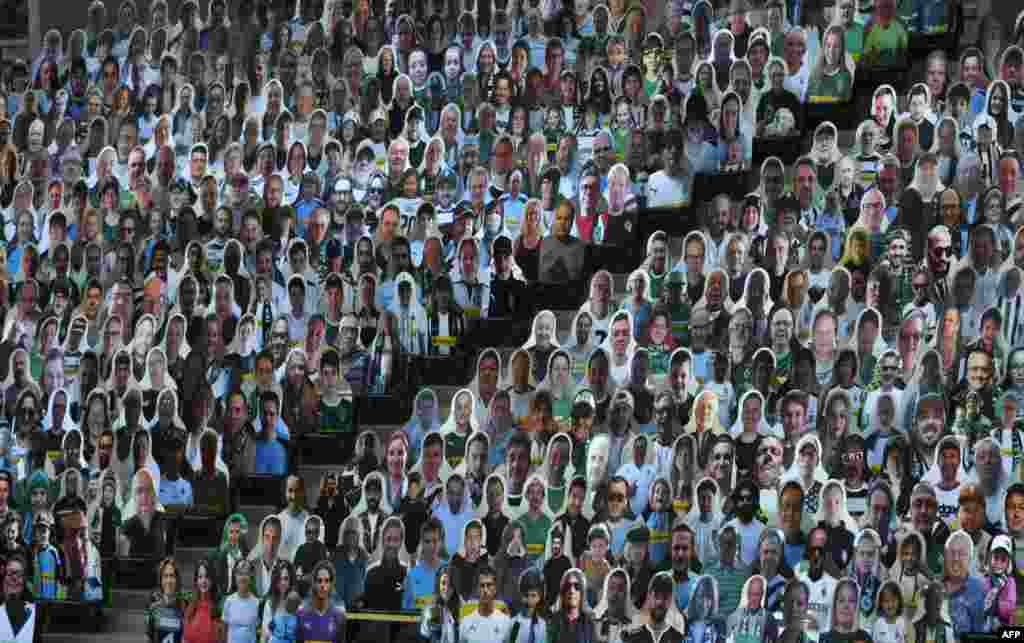 Cardboard cut-outs with portraits of Borussia Moenchegladbach&#39;s supporters are seen at the Borussia Park football stadium in Moenchengladbach, western Germany, amid the COVID-19 pandemic.