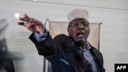 Kenyan opposition politician Miguna Miguna, who also holds Canadian citizenship and travels on a Canadian passport, reacts after Kenyan immigration authorities denied him entry into the country without a Kenyan visa, at Jomo Kenyatta International Airport