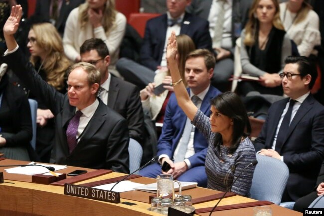 U.S. Ambassador to the United Nations Nikki Haley votes among other members of the United Nations Security Council to impose new sanctions on North Korea, at U.N. headquarters in New York, Dec. 22, 2017.