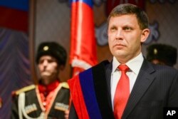 FILE - In this Nov. 4, 2014, photo, rebel leader Alexander Zakharchenko attends a swearing in ceremony in Donetsk, Ukraine.