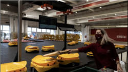 An employee places a parcel on a robot at the Hellenic Post's sorting centre in Kryoneri, Greece, October 4, 2021. Picture taken October 4, 2021. REUTERS/Alkis Konstantinidis