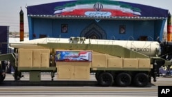 Iran's Khoramshahr missile is displayed by the Revolutionary Guard during a military parade marking the 37th anniversary of Iraq's 1980 invasion of Iran, in front of the shrine of late revolutionary founder Ayatollah Khomeini, near Tehran, Iran, Sept. 22,