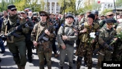 Pro-Russian rebels guard Victory Day celebrations in Donetsk, eastern Ukraine on May 9, 2014.