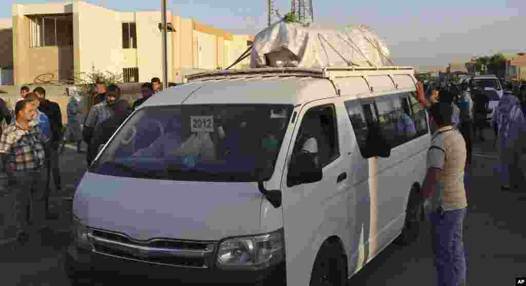 Mourners grieve as the body of a bomb attack victim is taken for burial during a funeral procession in al-Amel, Baghdad, Oct. 21, 2013. 