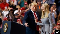 FILE - President Donald Trump greets his daughter Ivanka as she arrives to speak during a rally in Cleveland, Nov. 5, 2018. 