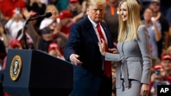 FILE - President Donald Trump greets his daughter Ivanka as she arrives to speak during a rally in Cleveland, Nov. 5, 2018. 