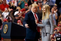 President Donald Trump greets his daughter Ivanka Trump as she arrives to speak during a rally in Cleveland, Nov. 5, 2018.