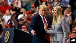 FILE - President Donald Trump greets his daughter Ivanka Trump as she arrives to speak during a rally in Cleveland, Nov. 5, 2018. The Chinese government granted 18 trademarks to companies linked to President Trump and his daughter Ivanka over the last two