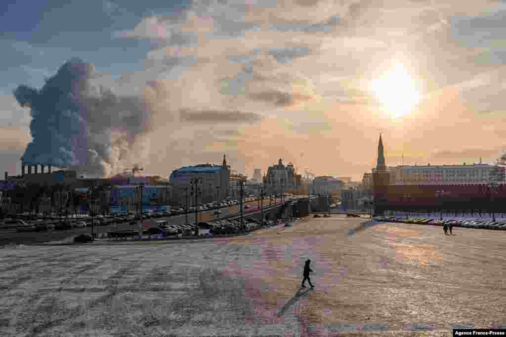 A man walks on Vasilyevsky Spusk (The Basil&#39;s Downhill) at the Kremlin during a frosty day, with the air temperature at around minus 21 degrees Celsius, in downtown Moscow.
