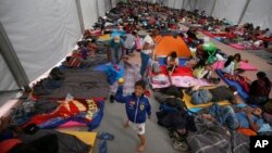 Central American migrants, part of a caravan hoping to reach the U.S. gets settled in a shelter at the Jesus Martinez stadium, in Mexico City, Nov. 5, 2018. 