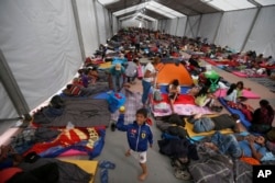 Central American migrants, part of a caravan hoping to reach the U.S. gets settled in a shelter at the Jesus Martinez stadium, in Mexico City, Nov. 5, 2018.