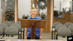 In this Thursday, Nov. 29, 2018, photograph, 9-year-old Dane Best poses in the council chambers in Severance, Colo. Dane is trying to get rid of his town's ban on snowballs and officials are wondering what took so long. (Sara Knuth/Greeley Tribune via AP)