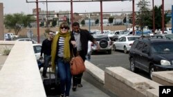 Travelers make their way to the departure lounge at Sana'a International Airport, Yemen, Aug. 6, 2013. 