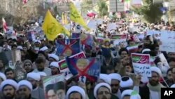 This frame grab from video provided by Iran Press, a pro-government news agency based in Beirut, shows pro-government demonstrators marching in Qom, Iran, Jan. 3, 2018. Iranian state TV channels aired footage of pro-government demonstrations in cities acr