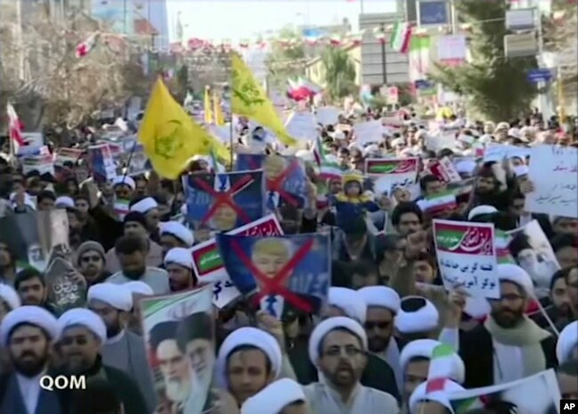 This frame grab from video provided by Iran Press, a pro-government news agency based in Beirut, shows pro-government demonstrators marching in Qom, Iran, Jan. 3, 2018. Iranian state TV channels aired footage of pro-government demonstrations in cities across Iran.